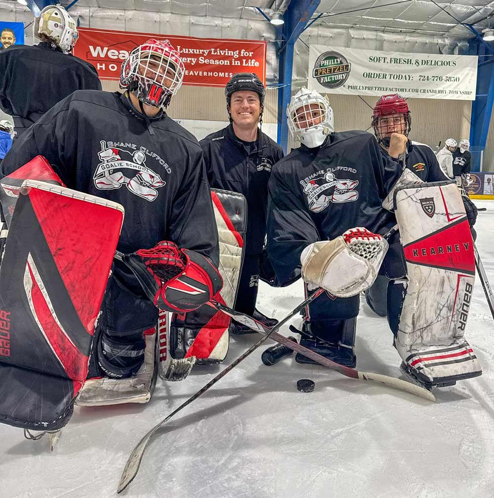 Coach Utah instructor with youth hockey goalies during on-ice training — Parents & Goalies resources page